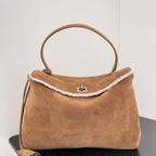 Camel suede top handle bag with shearling trim and silver turn-lock closure